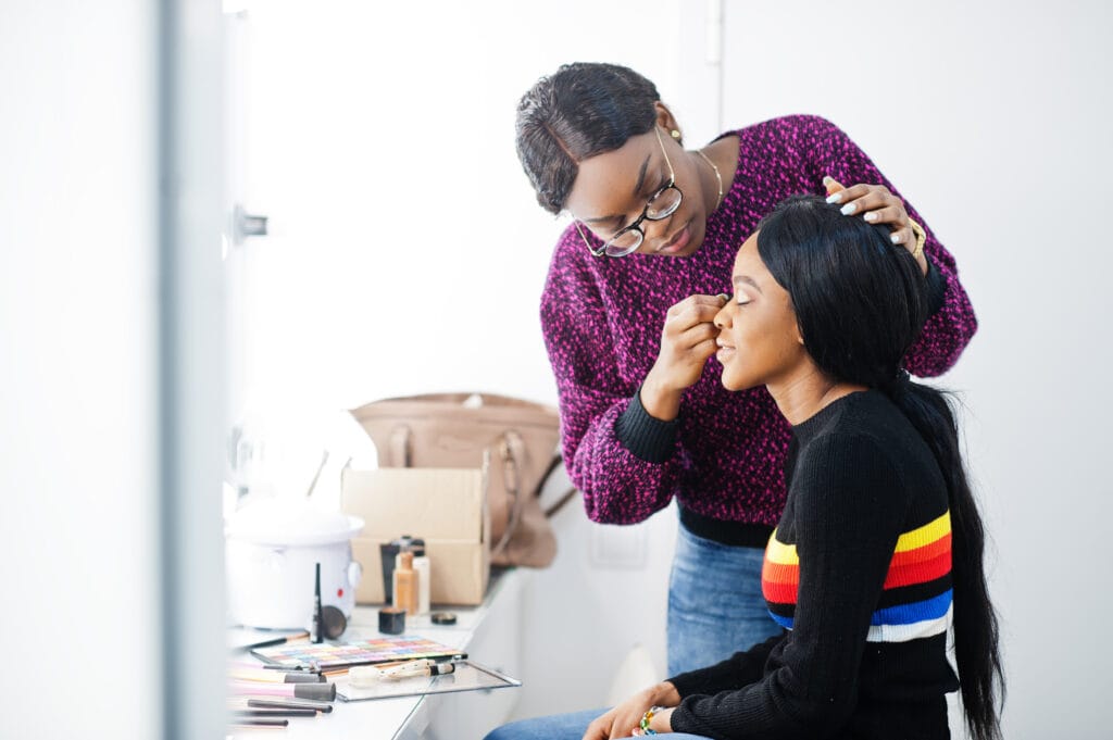 Woman getting her makeup done at a beauty salon